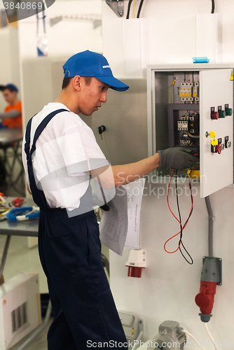 Image of Young electrician performs task of competition