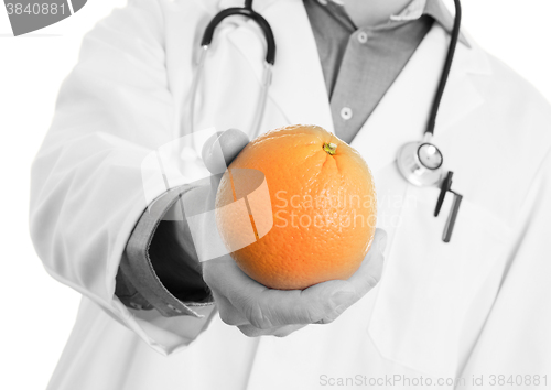 Image of Nutritionist doctor, giving an orange, isolated