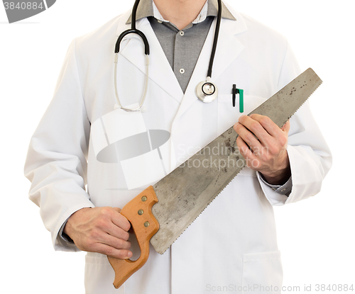 Image of Crazy doctor is holding a big saw in his hands