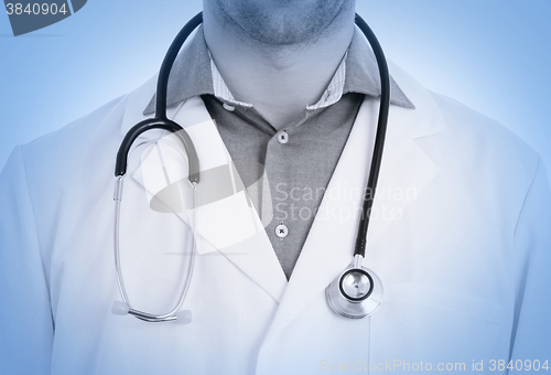 Image of Close up of male doctor with stethoscope, medical blue