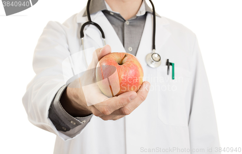 Image of Nutritionist doctor, giving an apple, isolated