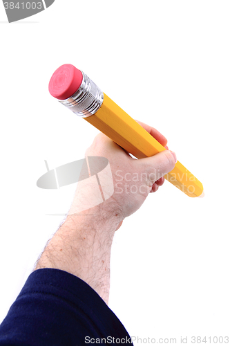 Image of big pencil in human hand