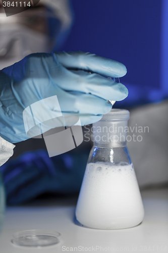 Image of close up of scientist making test in lab