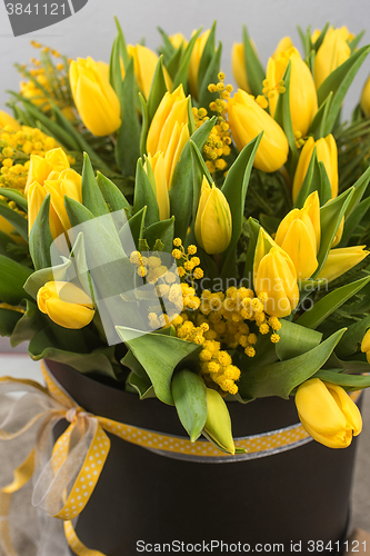 Image of Bright spring bouquet of tulips and mimosa flowers