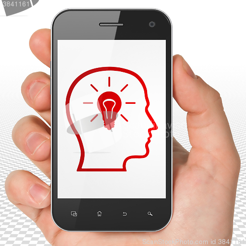 Image of Information concept: Hand Holding Smartphone with Head With Lightbulb on display