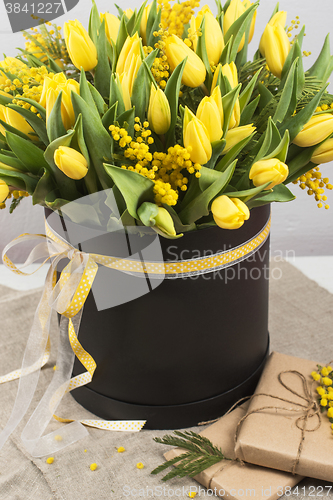 Image of Bright spring bouquet of tulips and mimosa flowers