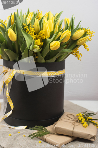 Image of Bright spring bouquet of tulips and mimosa flowers