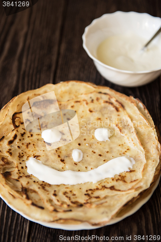 Image of Fried tasty smiling pancakes 