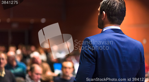 Image of Public speaker giving talk at Business Event.