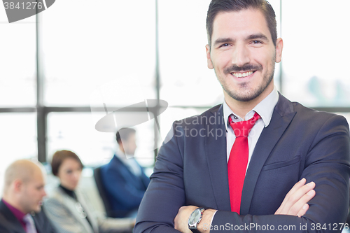Image of Team leader with coworkers working in office.