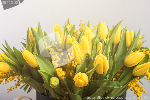 Image of Bright spring bouquet of tulips and mimosa flowers