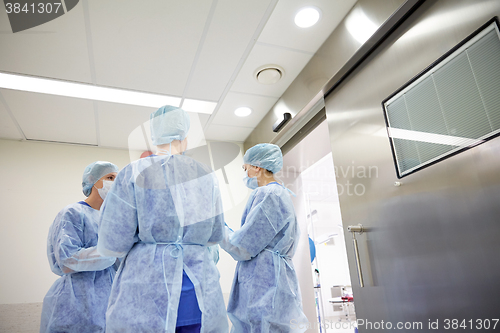 Image of group of surgeons in operating room at hospital