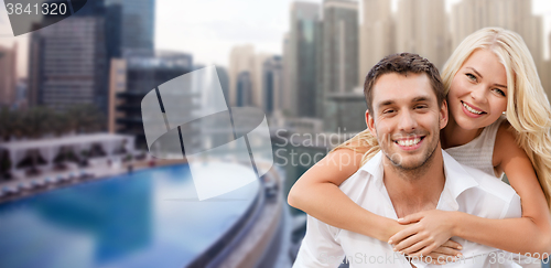 Image of happy couple having fun over dubai city background