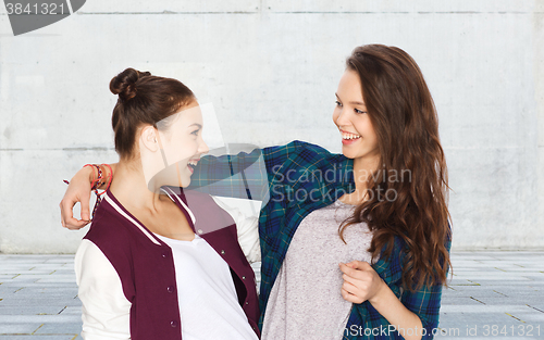 Image of happy smiling pretty teenage girls hugging