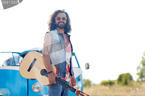 Image of hippie man with guitar over minivan car outdoor