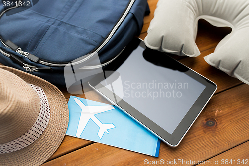 Image of close up of tablet pc and traveler personal stuff