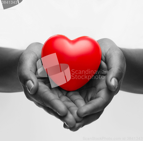 Image of female hands with small red heart