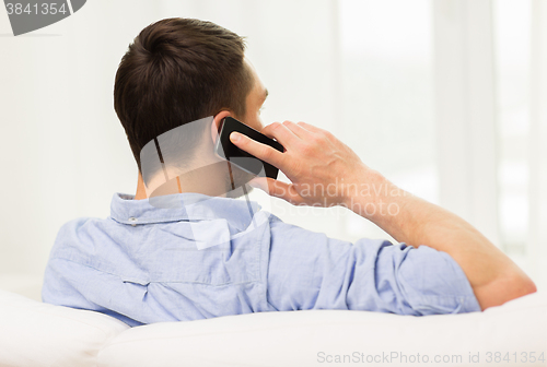 Image of close up of man calling on smartphone at home