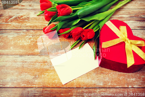 Image of close up of red tulips, letter and chocolate box