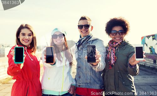 Image of smiling friends showing blank smartphone screens