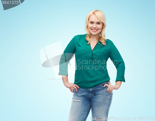 Image of smiling young woman in shirt and jeans