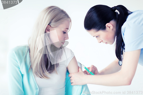 Image of doctor doing vaccine to patient