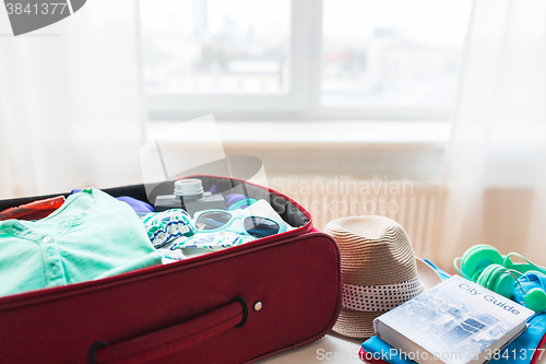 Image of close up of travel bag with clothes and stuff