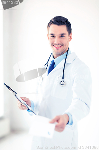 Image of male doctor writing prescription