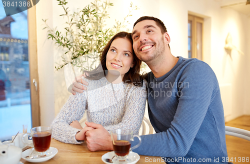 Image of happy couple drinking tea at restaurant
