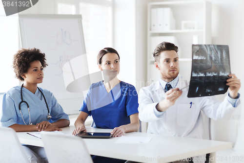 Image of group of doctors discussing x-ray image