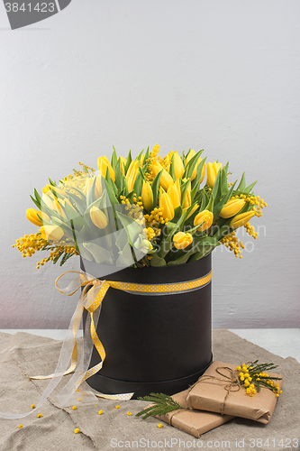 Image of Bright spring bouquet of tulips and mimosa flowers