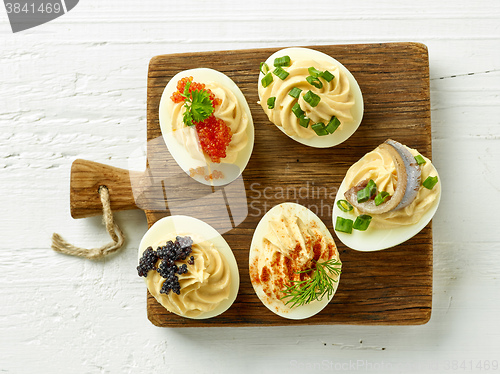 Image of boiled decorative eggs on wooden cutting board