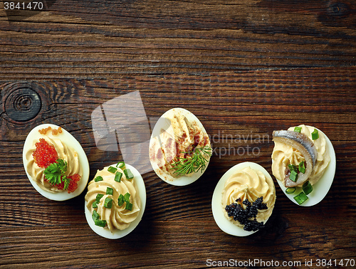 Image of stuffed eggs on wooden table