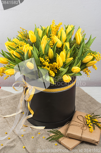 Image of Bright spring bouquet of tulips and mimosa flowers