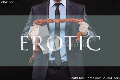 Image of man in business suit with chained hands. handcuffs for sex games. concept of erotic entertainment. erotic