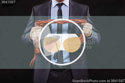 Image of man in business suit with chained hands. handcuffs for sex games. concept of erotic entertainment.
