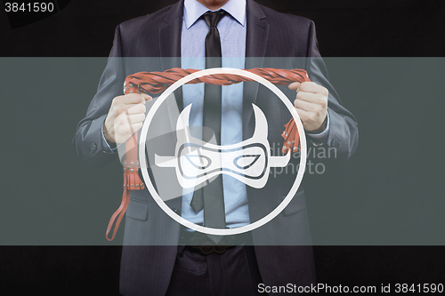 Image of man in business suit with chained hands. handcuffs for sex games. concept of erotic entertainment.