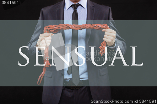 Image of man in business suit with chained hands. handcuffs for sex games. concept of erotic entertainment. sensual