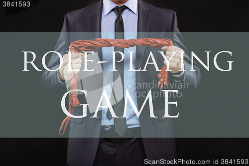 Image of man in business suit with chained hands. handcuffs for sex games. concept of erotic entertainment. role playing game