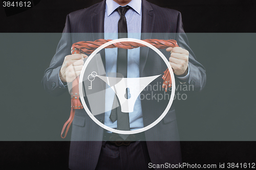 Image of man in business suit with chained hands. handcuffs for sex games. concept of erotic entertainment.