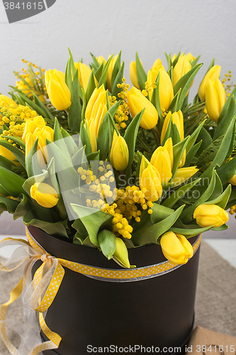 Image of Bright spring bouquet of tulips and mimosa flowers