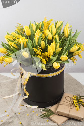 Image of Bright spring bouquet of tulips and mimosa flowers