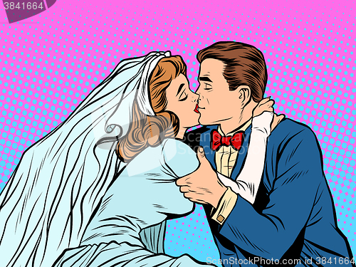 Image of The bride and groom kiss