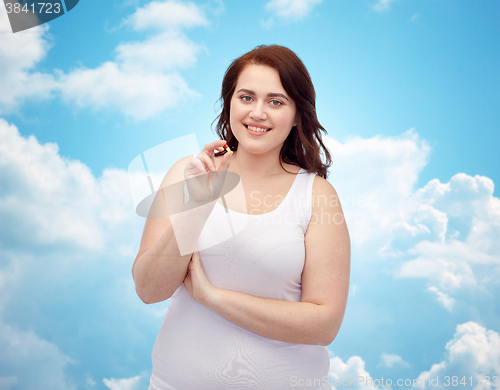 Image of happy plus size woman in underwear with pill