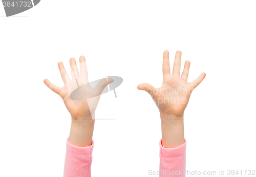 Image of close up of little child hands raised upwards