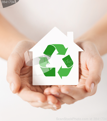 Image of hands holding house with green recycling sign