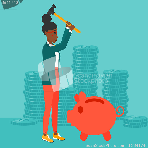 Image of Woman breaking piggy bank.