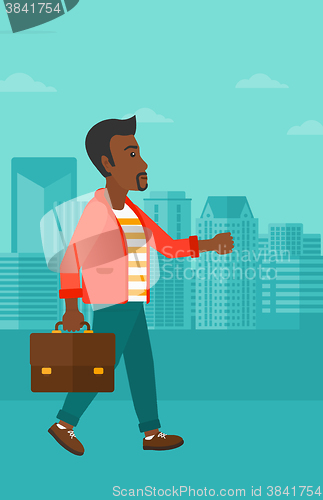 Image of Businessman walking with briefcase. 