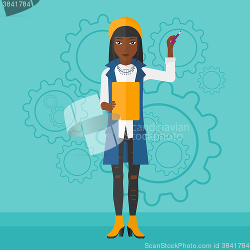 Image of Woman standing on gears background.