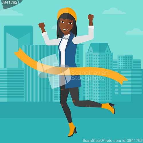 Image of Business woman crossing finish line.